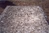 The top of the casket next to the column tombstone.