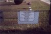 A sign that hangs on the chain link fence of the TCM cemetery.